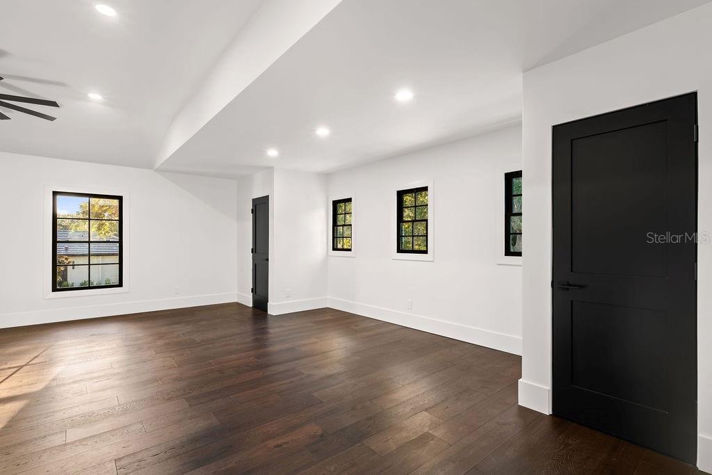 9725 Chestnut Ridge Drive Windermere, FL 34786 - Photo 43 of 61 a view of an empty room with wooden floor and a window