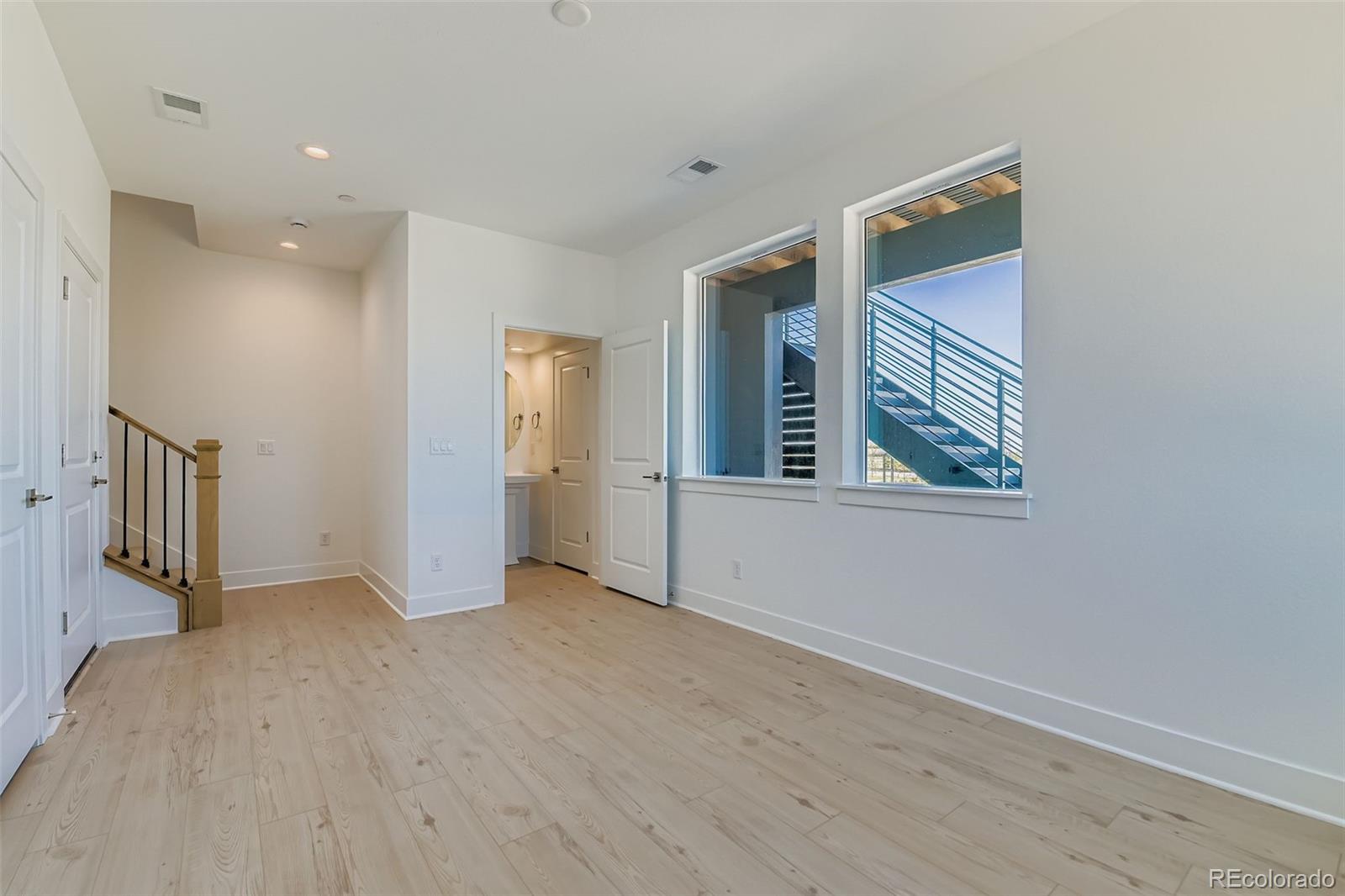 622 Saddle Drive Erie, CO 80516 - Photo 2 of 25 wooden floor in an empty room with a window