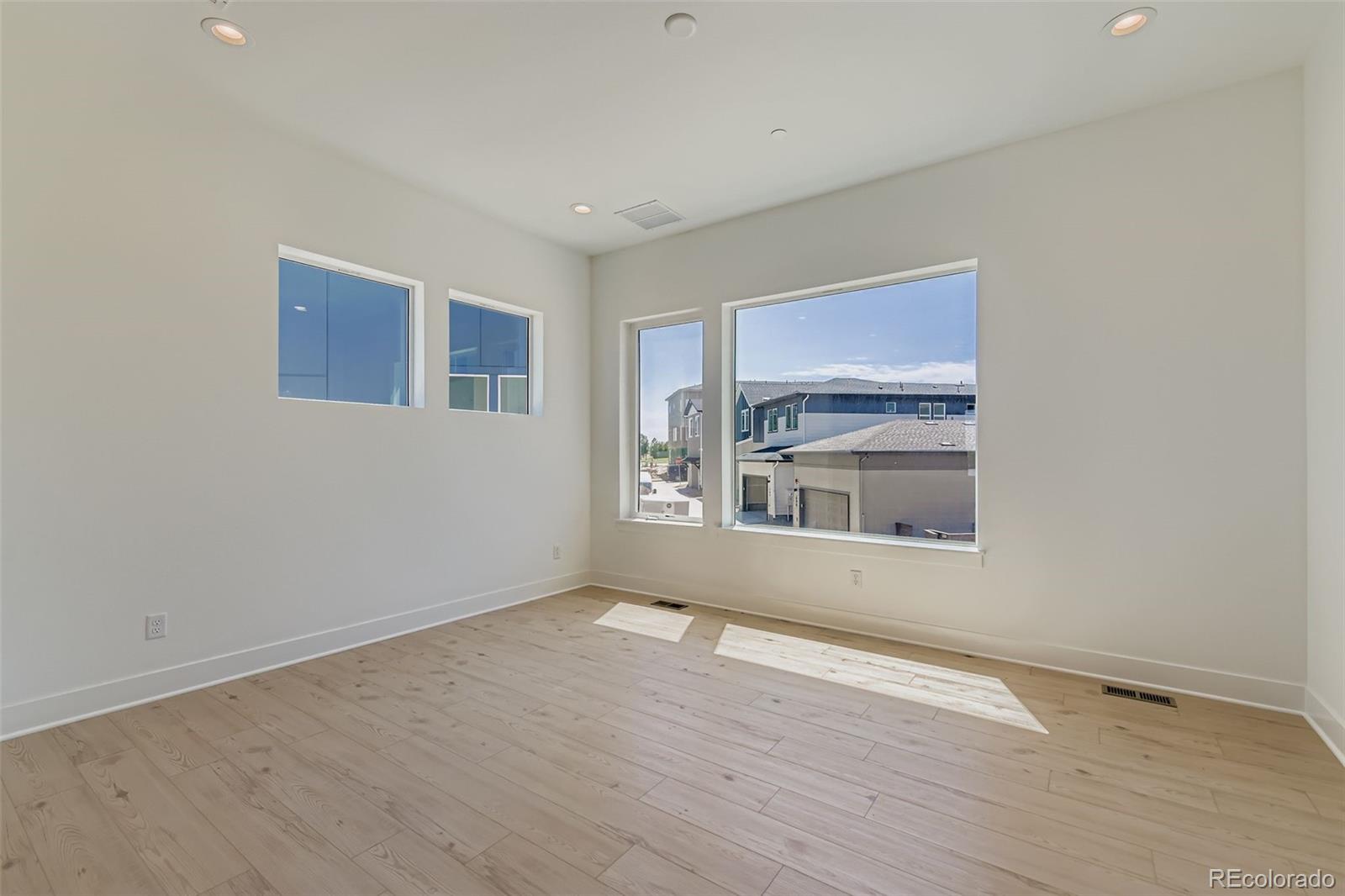 622 Saddle Drive Erie, CO 80516 - Photo 4 of 25 a view of an empty room with wooden floor and a window