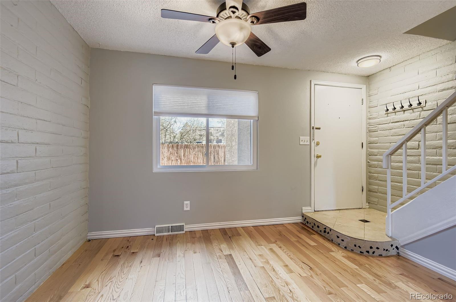 1060 South Parker Road, Unit 25 Denver, CO 80231 - Photo 15 of 26 wooden floor in an empty room with a window