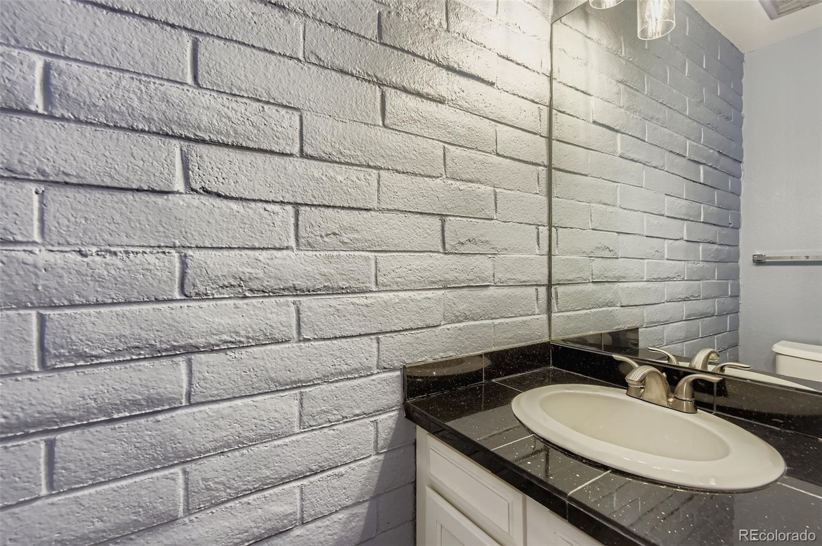 1060 South Parker Road, Unit 25 Denver, CO 80231 - Photo 8 of 26 a bathroom with a granite countertop sink and a mirror