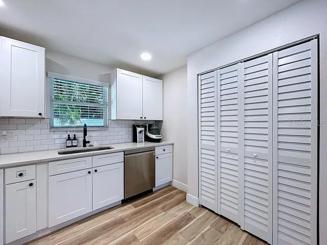 a kitchen with a sink and cabinets