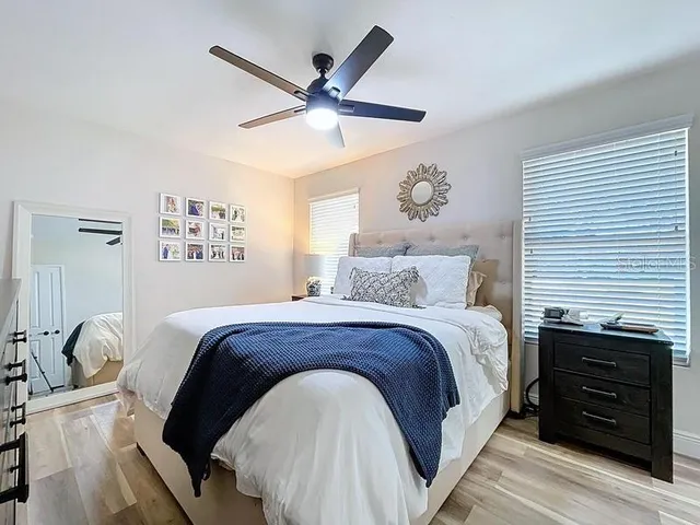 a bedroom with a large bed and a chandelier
