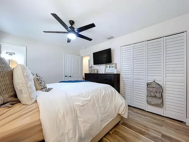 a bedroom with a bed and a flat screen tv