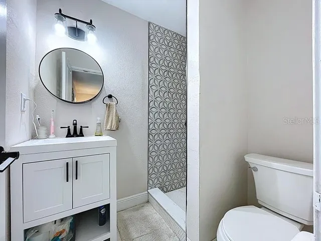 a bathroom with a toilet a sink and a mirror