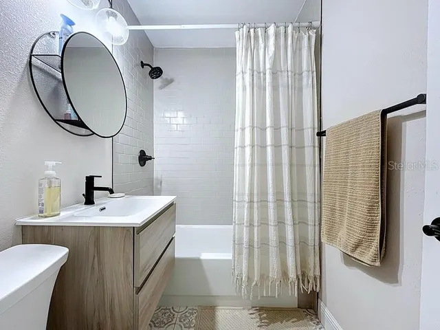 a bathroom with a sink a toilet and a mirror