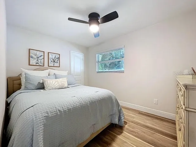 a bedroom with a bed and a mirror