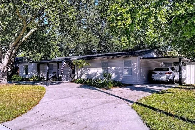 a view of a patio with a table and chairs under an umbrella