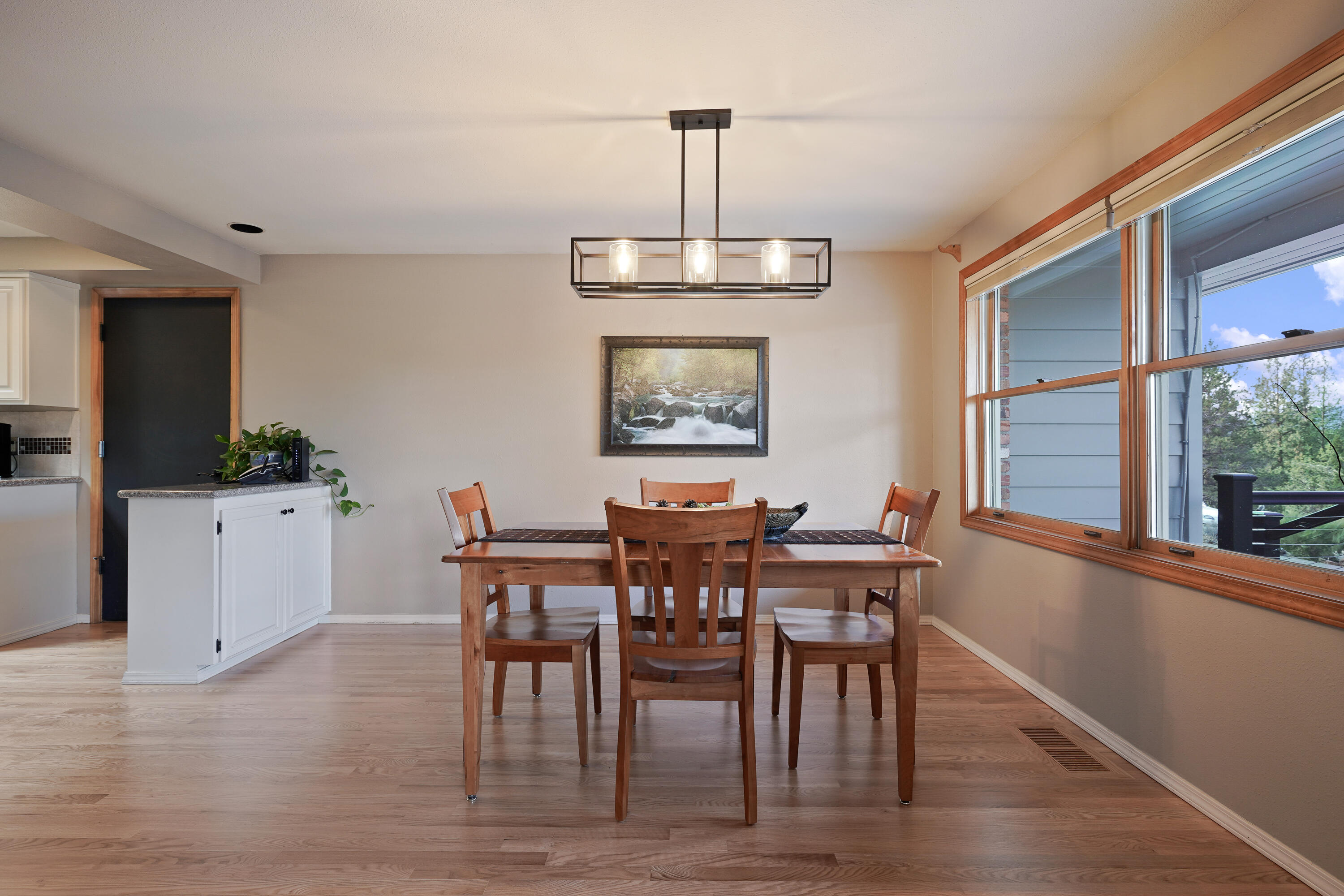 70030 Meadow View Road Sisters, OR 97759 - Photo 41 of 43 a view of a dining room with furniture window and wooden floor