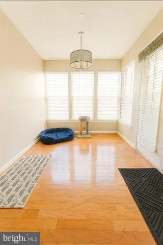a view of a room with wooden floor and a large window