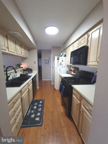 a kitchen with granite countertop a sink stove and refrigerator