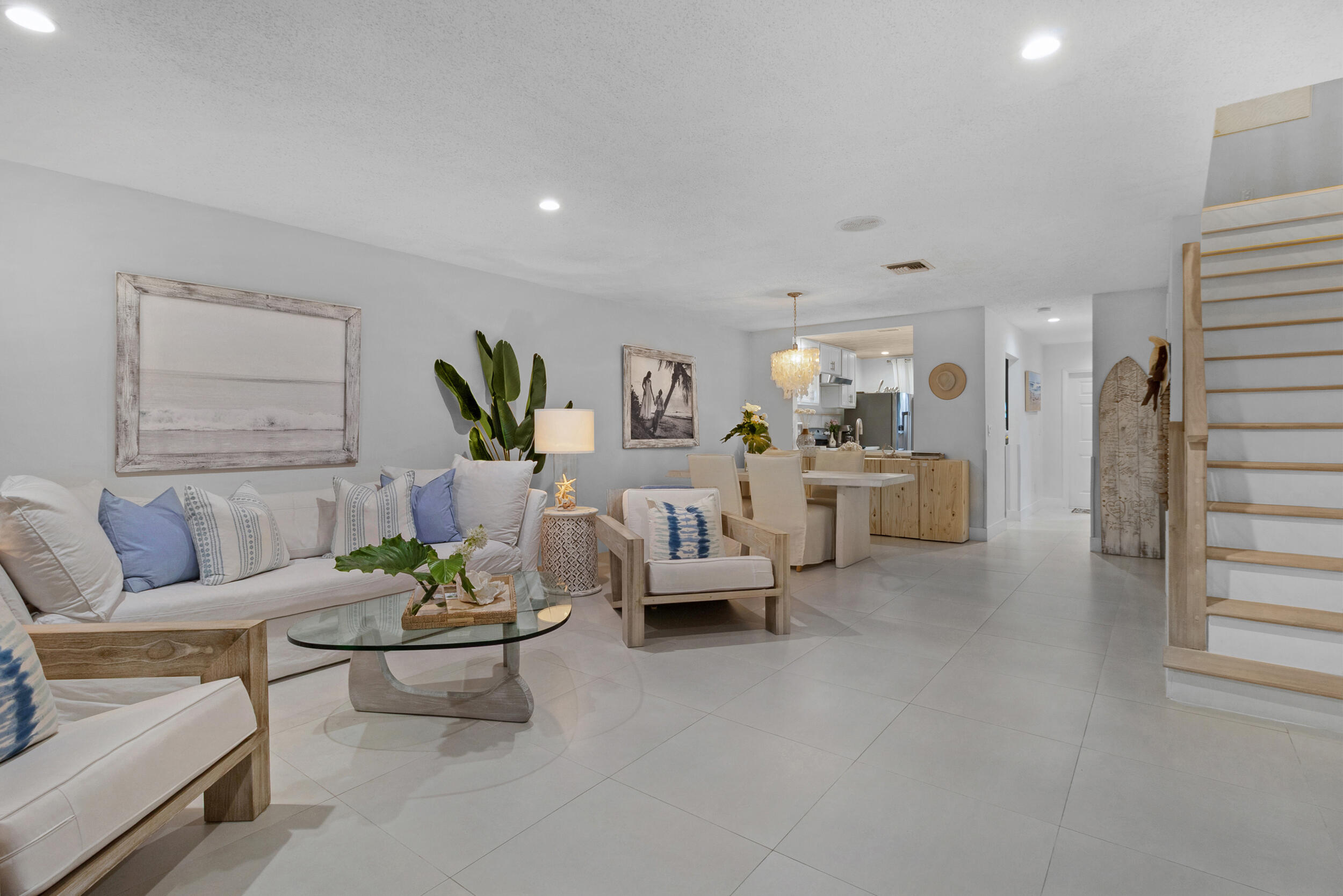 2136 Northeast 44th Street, Unit 4 Lighthouse Point, FL 33064 - Photo 22 of 51 a living room with furniture and paintings on the wall