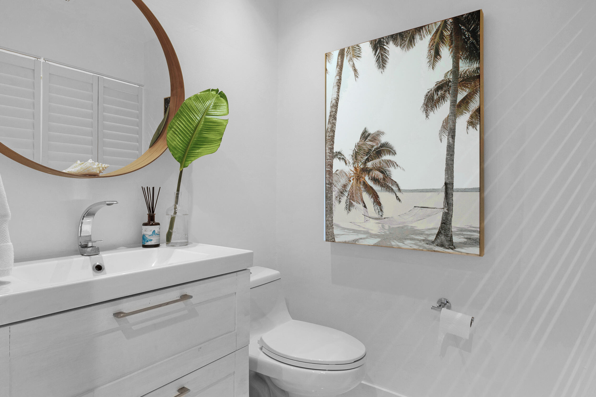 2136 Northeast 44th Street, Unit 4 Lighthouse Point, FL 33064 - Photo 23 of 51 a bathroom with a toilet sink and mirror