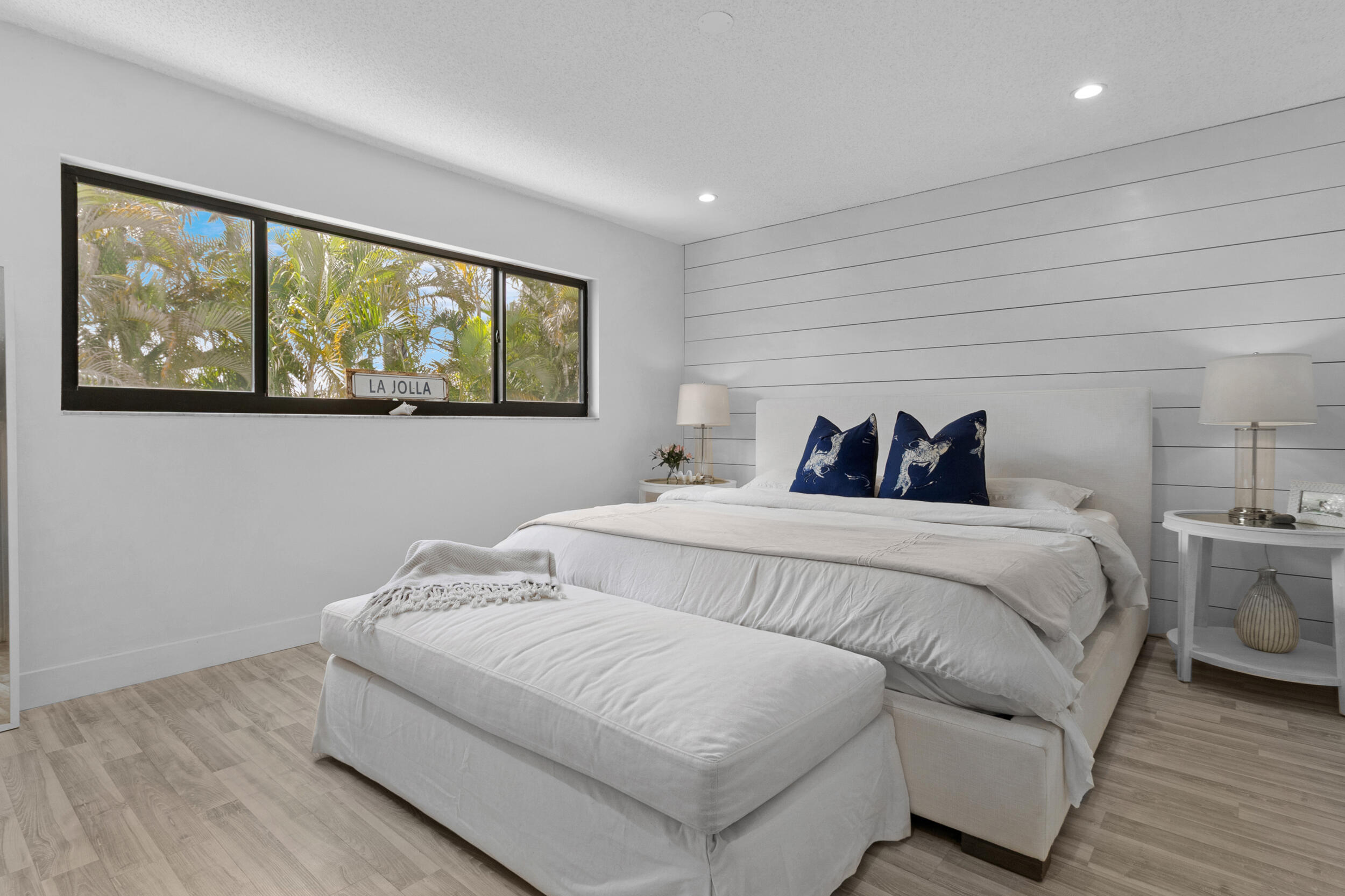 2136 Northeast 44th Street, Unit 4 Lighthouse Point, FL 33064 - Photo 27 of 51 a bedroom with a bed and a large window