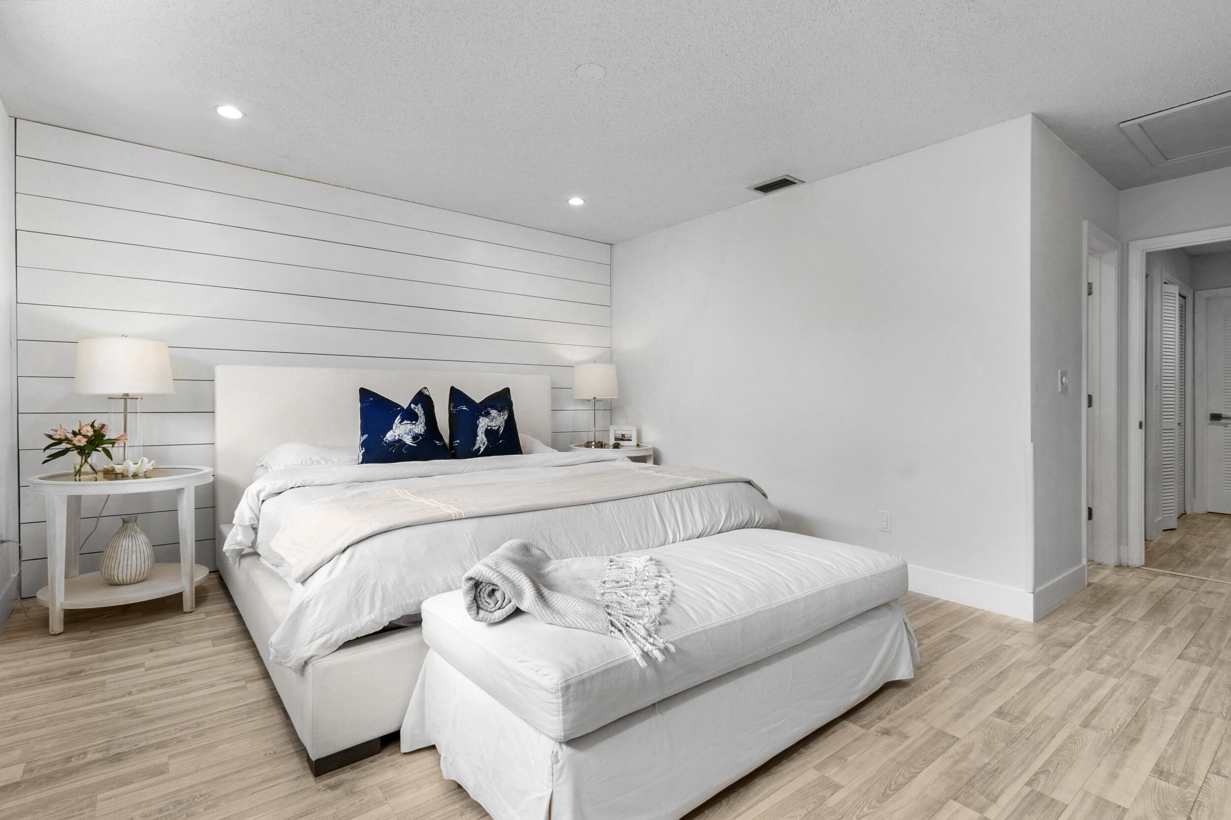 2136 Northeast 44th Street, Unit 4 Lighthouse Point, FL 33064 - Photo 29 of 51 a bedroom with a white bed and a couch