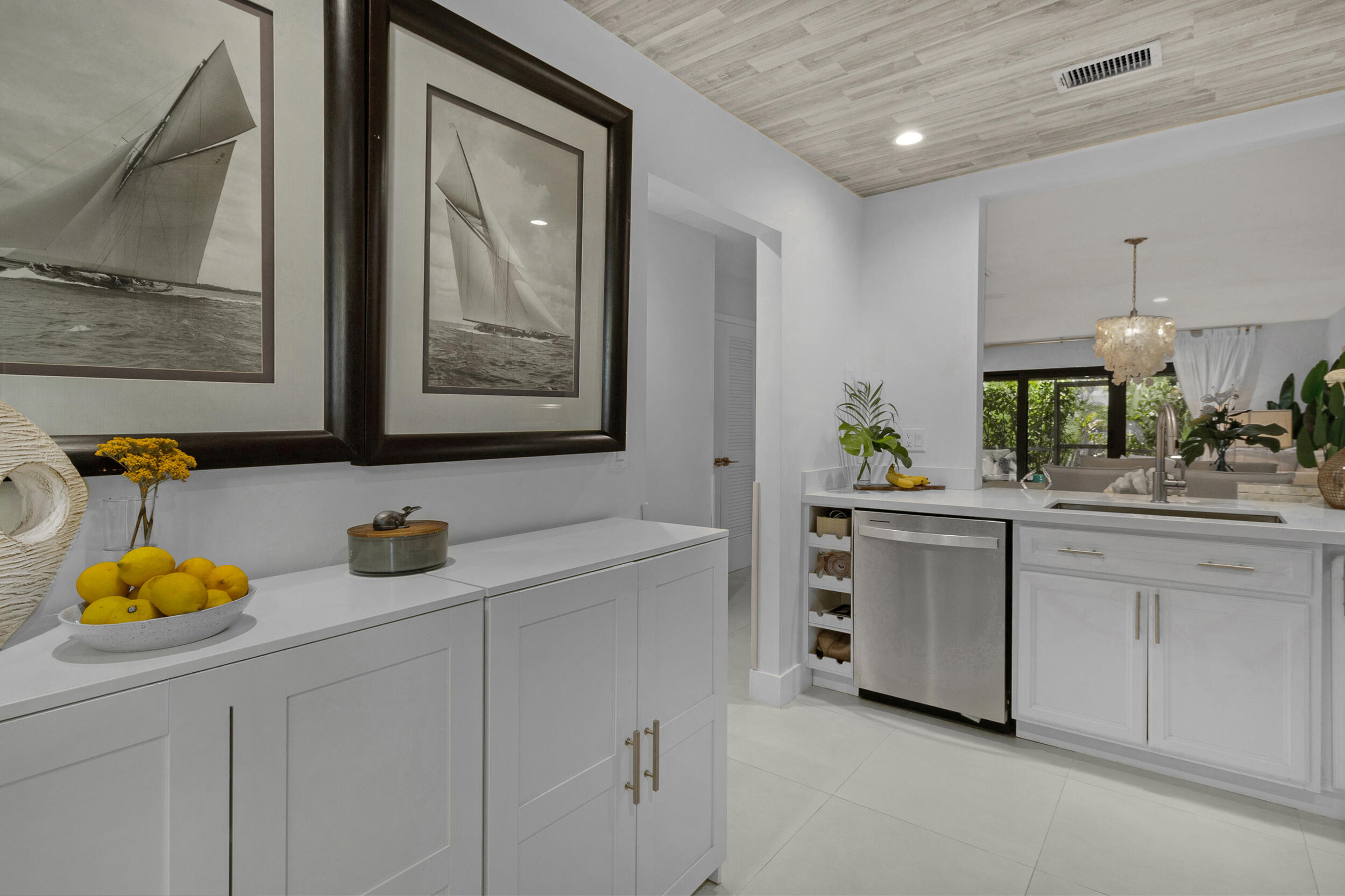2136 Northeast 44th Street, Unit 4 Lighthouse Point, FL 33064 - Photo 9 of 51 a kitchen with white cabinets and sink