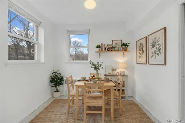 a dining room with furniture and window