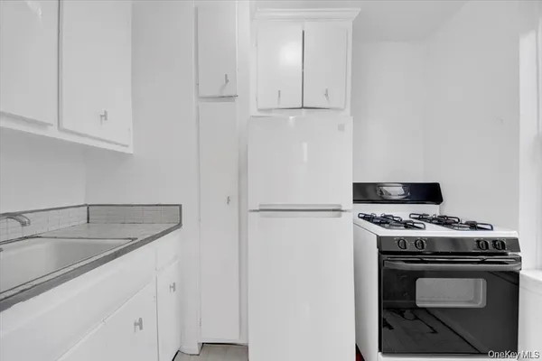 a kitchen with cabinets appliances and a sink