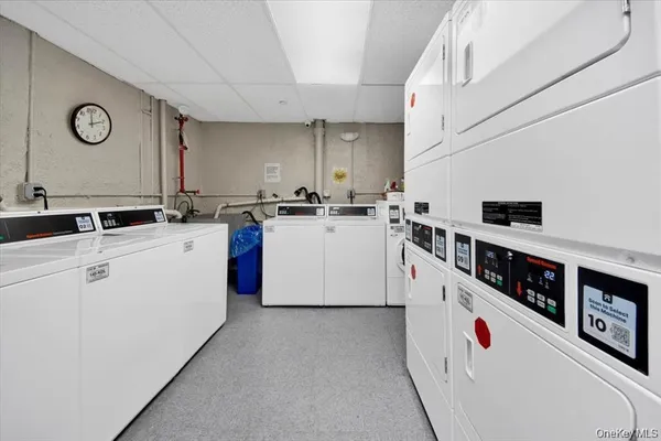 a kitchen with stainless steel appliances granite countertop a white stove top oven a sink and dishwasher with white cabinets