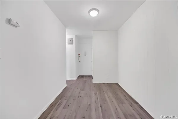 a view of a room with wooden floor