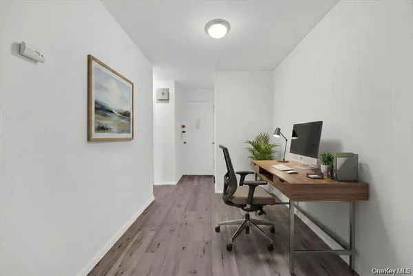 a view of a workspace with furniture and wooden floor