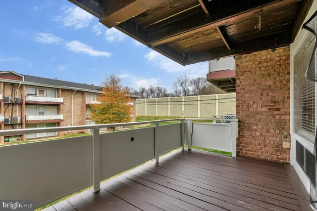 a view of a kitchen with a sink and dishwasher with wooden floor