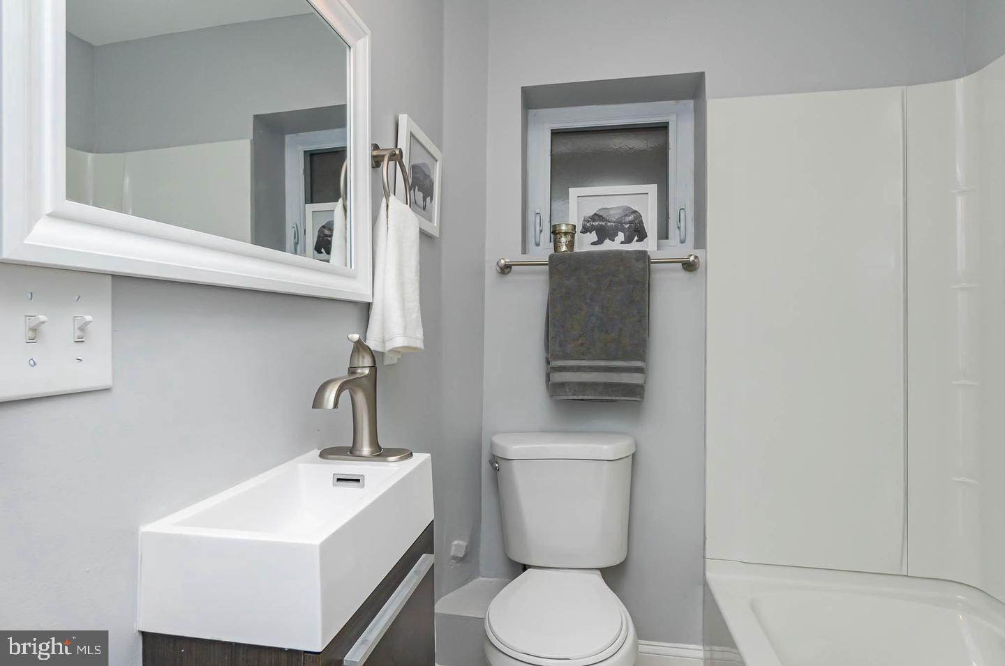 1709 Bank Street Baltimore, MD 21231 - Photo 19 of 49 a white toilet sitting next to a bathroom sink