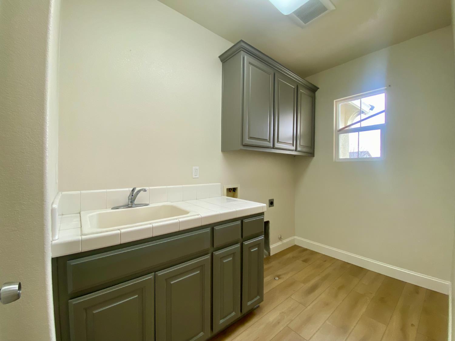 1227 CAVALAIRE Court Merced, CA 95348 - Photo 14 of 34 a utility room with a sink washer and dryer