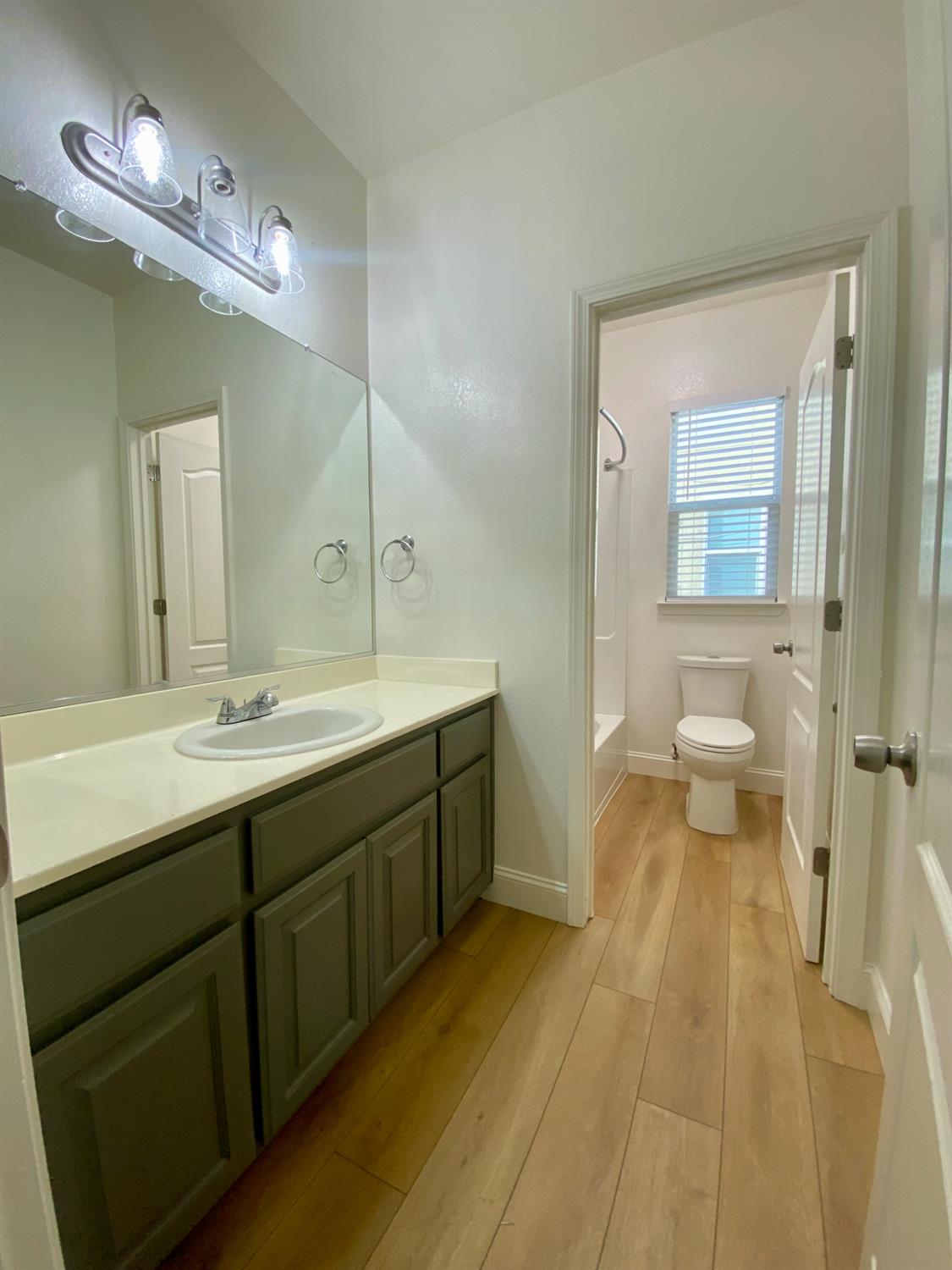 1227 CAVALAIRE Court Merced, CA 95348 - Photo 15 of 34 a spacious bathroom with a double vanity sink and a mirror
