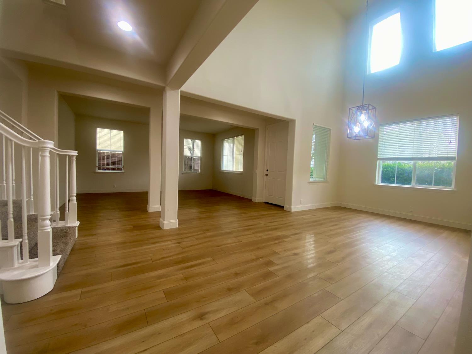1227 CAVALAIRE Court Merced, CA 95348 - Photo 5 of 34 an empty room with wooden floor and windows