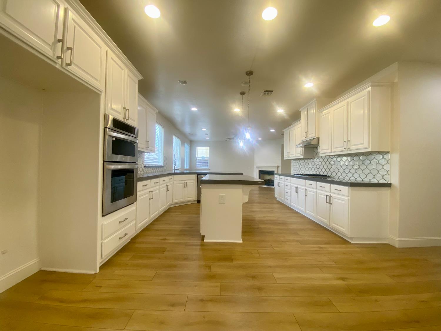 1227 CAVALAIRE Court Merced, CA 95348 - Photo 7 of 34 a kitchen with stainless steel appliances granite countertop a stove a sink and a refrigerator