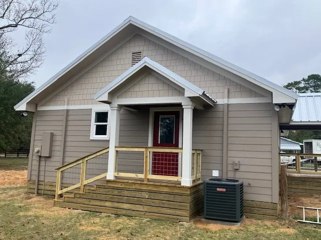 a kitchen with stainless steel appliances granite countertop a refrigerator a sink dishwasher a stove and a dining table with wooden floor