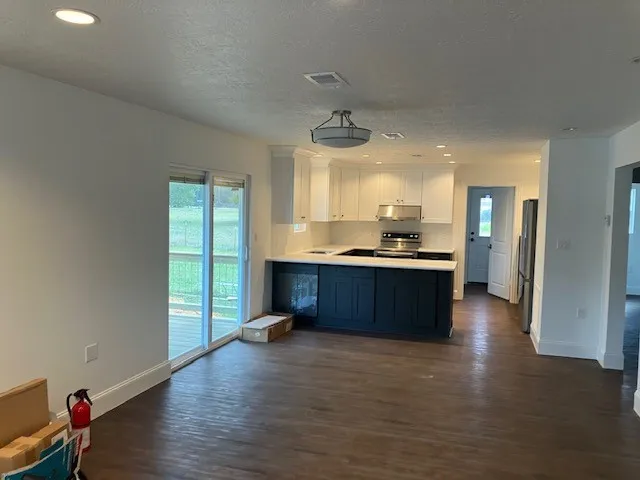 a kitchen with kitchen island a stove a sink and a refrigerator