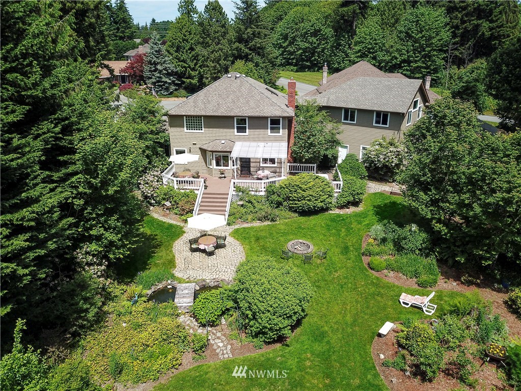 2716 187th Street Southeast Bothell, WA 98012 - Photo 2 of 37 a aerial view of a house with swimming pool and garden