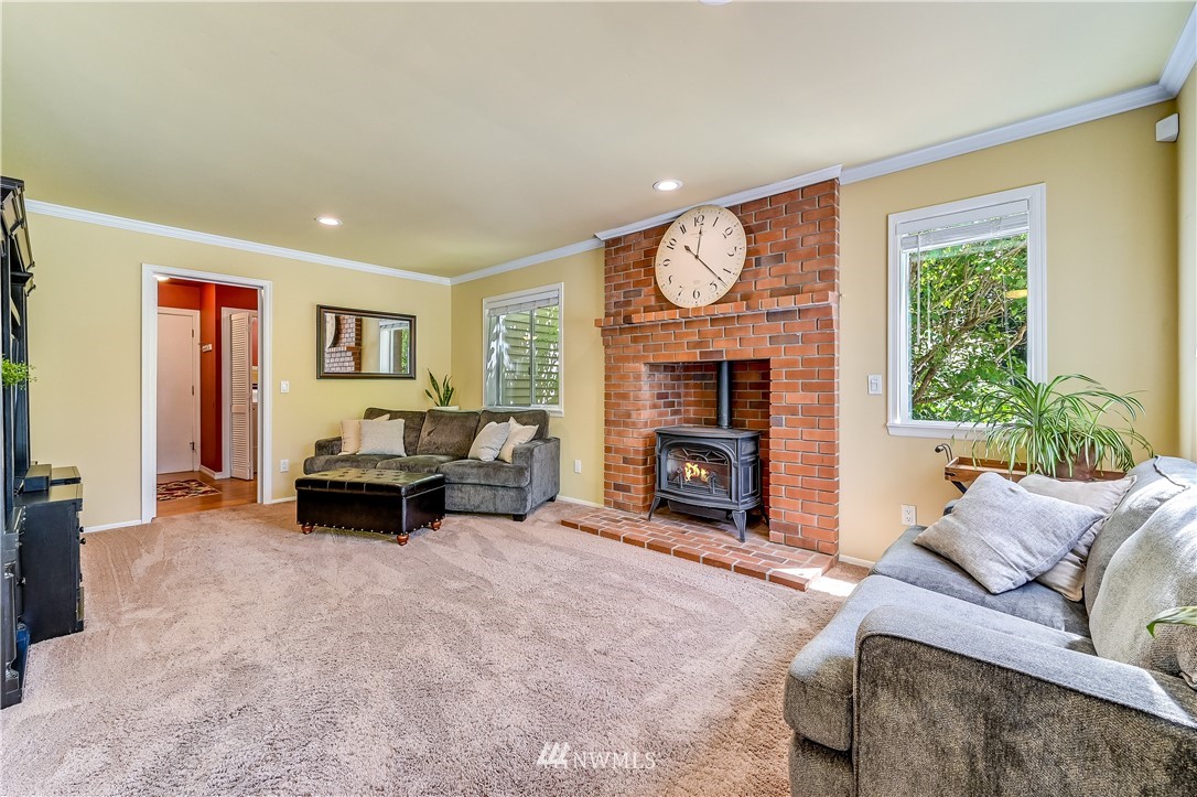 2716 187th Street Southeast Bothell, WA 98012 - Photo 11 of 37 a living room with furniture and a fireplace