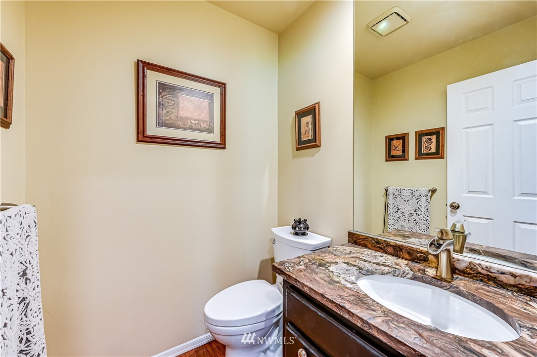 2716 187th Street Southeast Bothell, WA 98012 - Photo 14 of 37 a bathroom with a granite countertop sink and a mirror