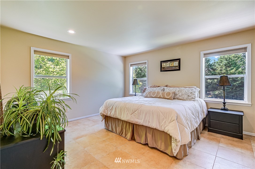 2716 187th Street Southeast Bothell, WA 98012 - Photo 16 of 37 a bedroom with a bed and a potted plant