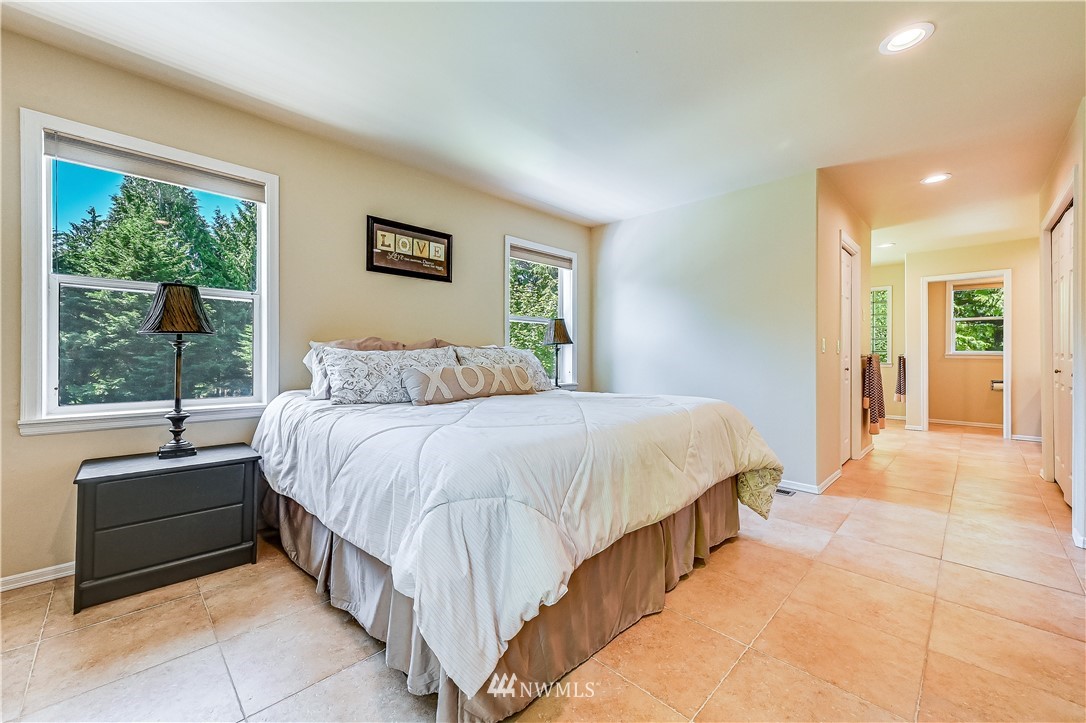 2716 187th Street Southeast Bothell, WA 98012 - Photo 17 of 37 a spacious bedroom with a bed and a large window