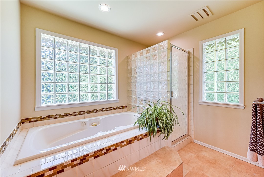 2716 187th Street Southeast Bothell, WA 98012 - Photo 18 of 37 a spacious bathroom with a tub and shower