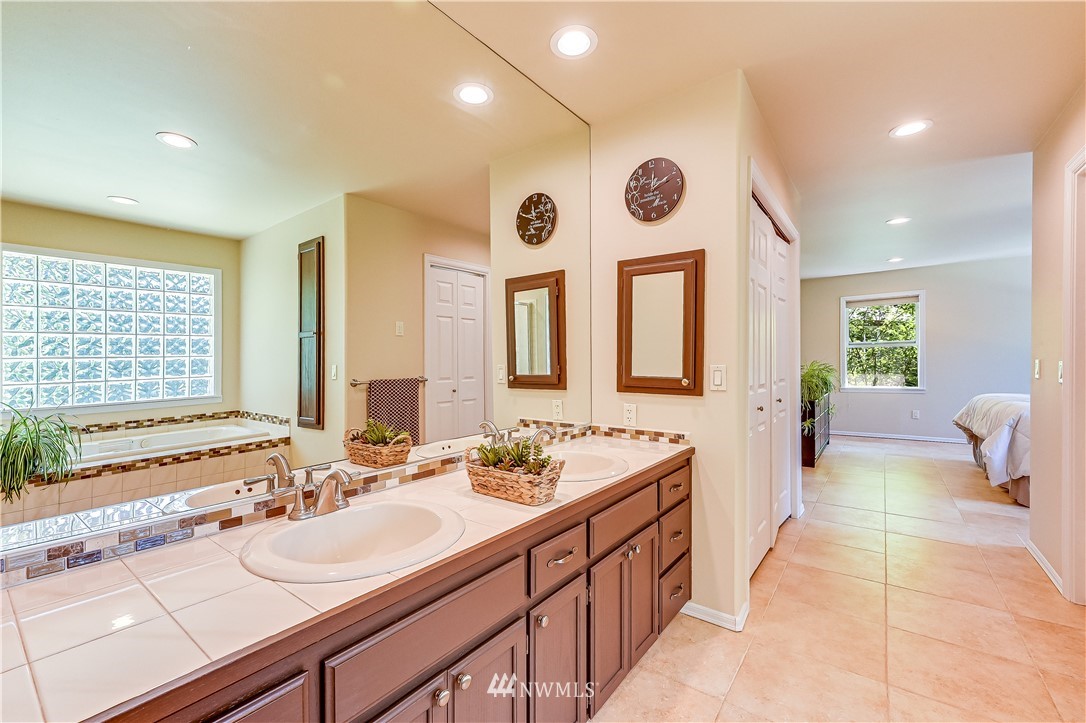 2716 187th Street Southeast Bothell, WA 98012 - Photo 19 of 37 a spacious bathroom with a double vanity sink and a large mirror