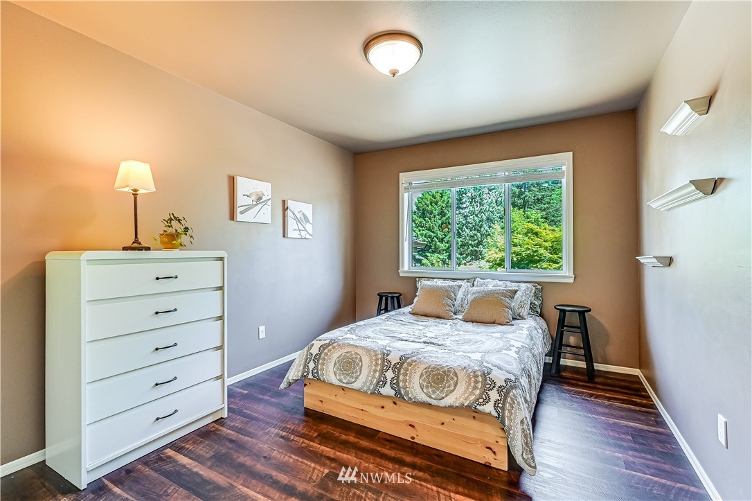 2716 187th Street Southeast Bothell, WA 98012 - Photo 23 of 37 a bedroom with a bed and a lamp on the dresser