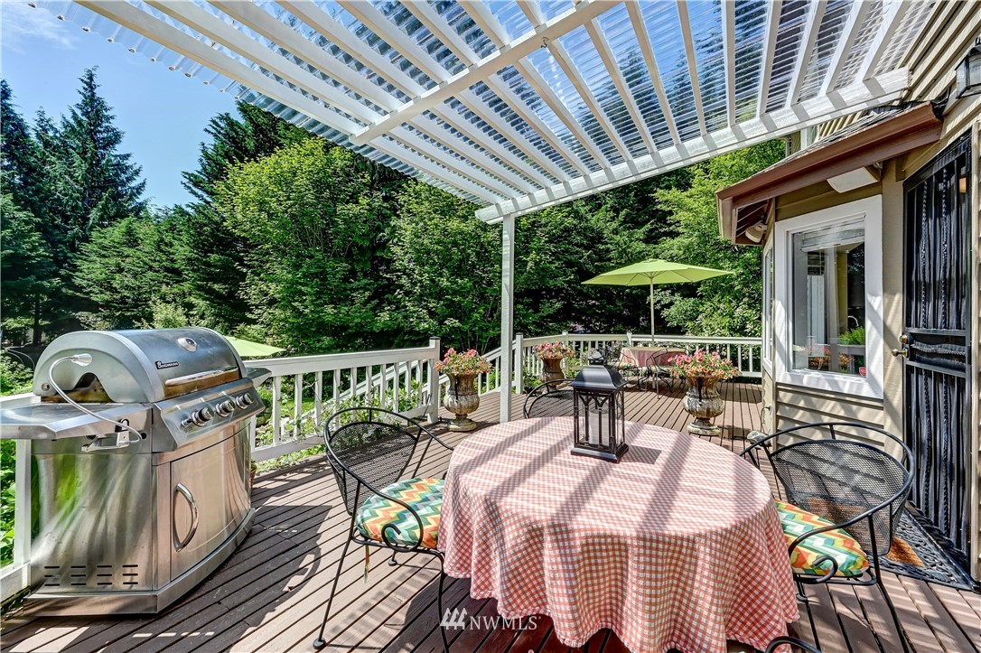 2716 187th Street Southeast Bothell, WA 98012 - Photo 28 of 37 a view of a patio with table and chairs potted plants with wooden floor and fence