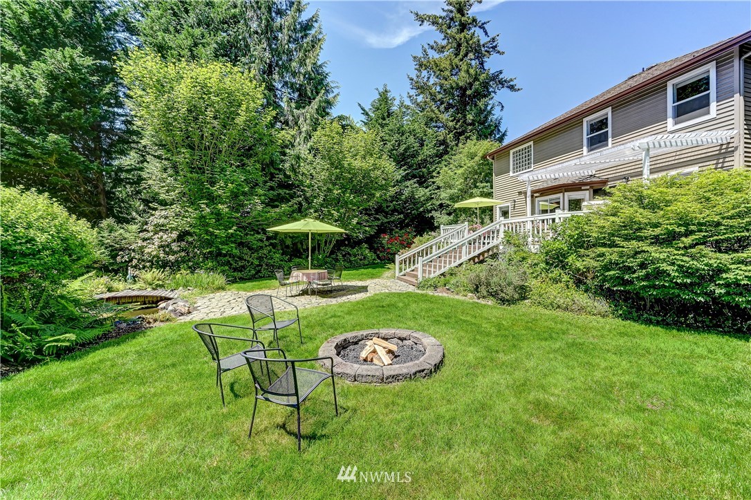 2716 187th Street Southeast Bothell, WA 98012 - Photo 32 of 37 a view of backyard with swimming pool and green space