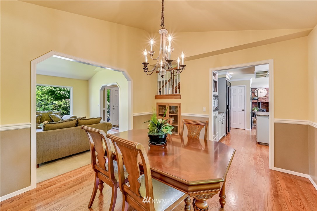 2716 187th Street Southeast Bothell, WA 98012 - Photo 7 of 37 a view of a dining room with furniture and wooden floor