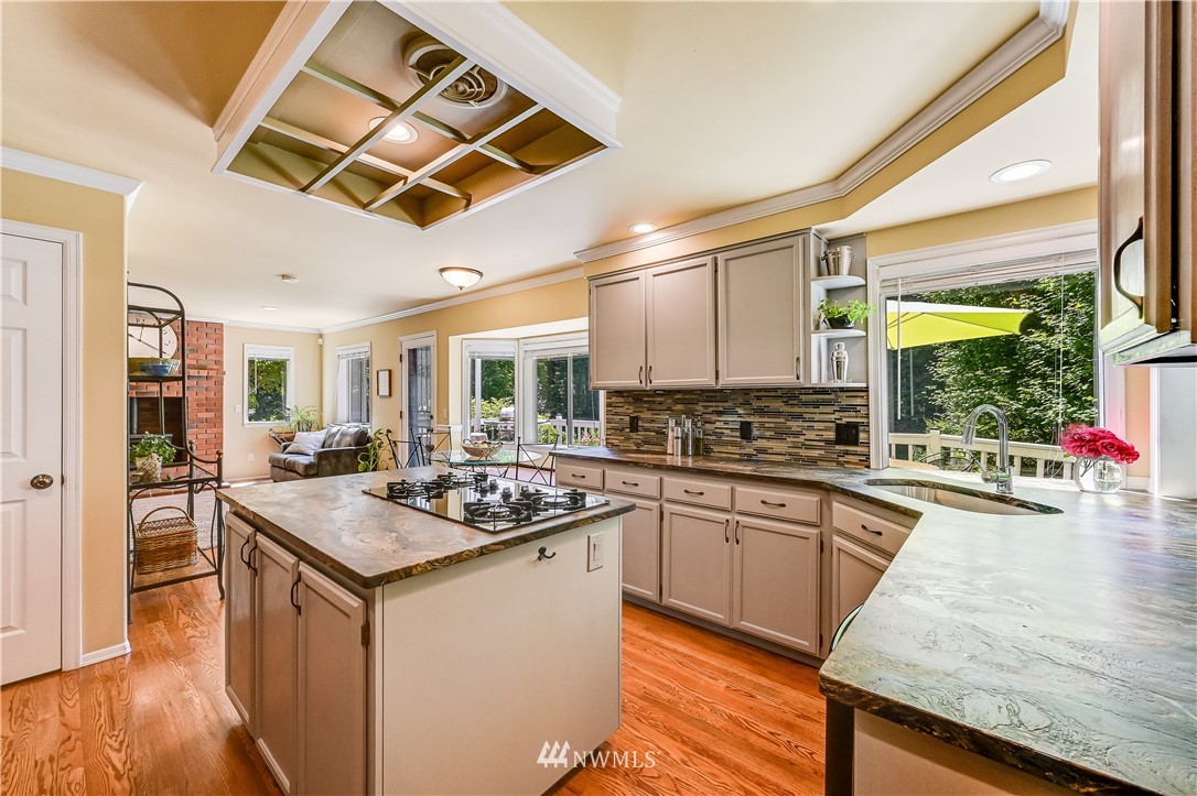 2716 187th Street Southeast Bothell, WA 98012 - Photo 9 of 37 a kitchen with stainless steel appliances granite countertop a stove a sink and a refrigerator
