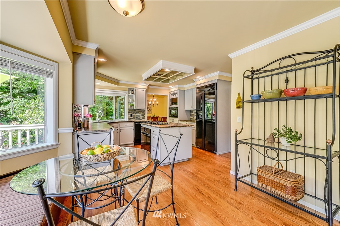 2716 187th Street Southeast Bothell, WA 98012 - Photo 10 of 37 a view of a dining room with furniture window and wooden floor