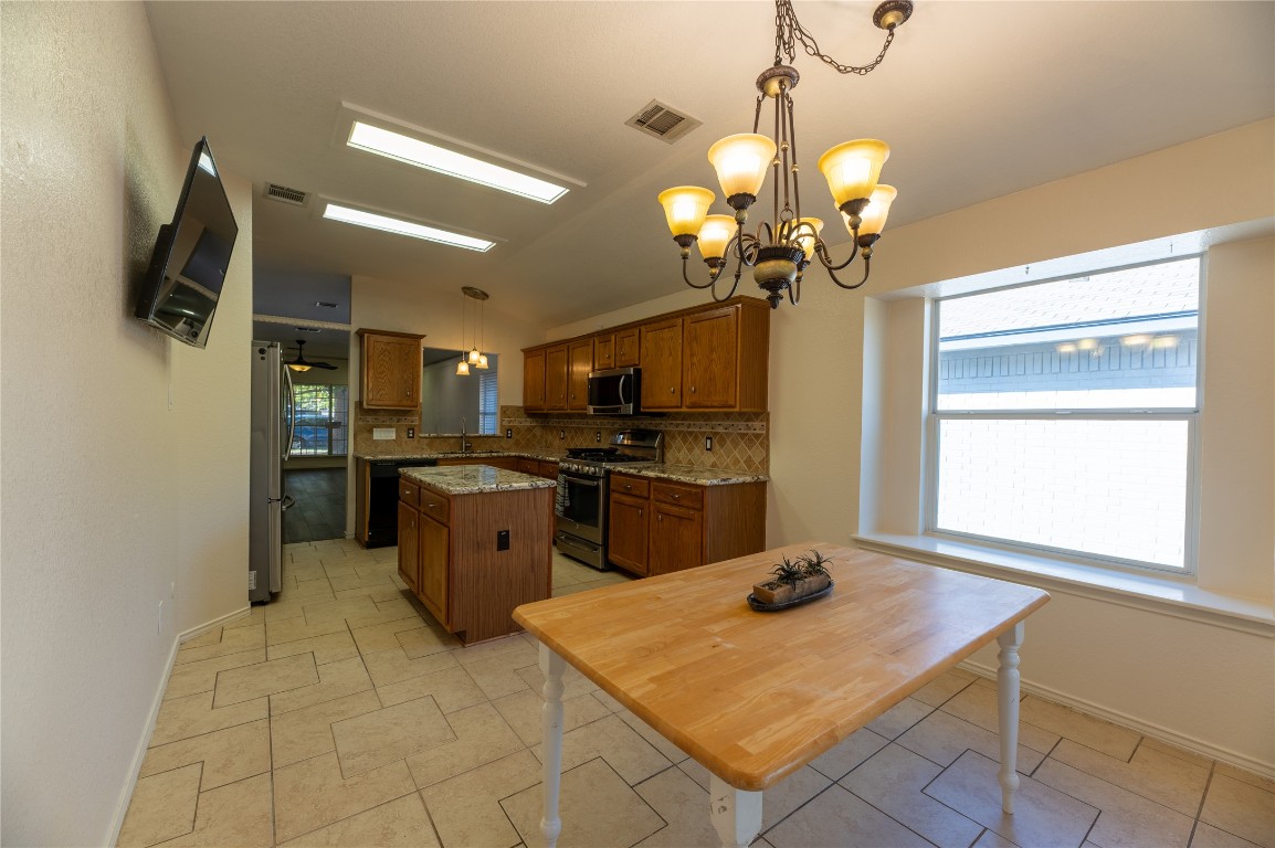 2604 Hutton Lane Leander, TX 78641 - Photo 12 of 27 a kitchen with a refrigerator a sink and dishwasher