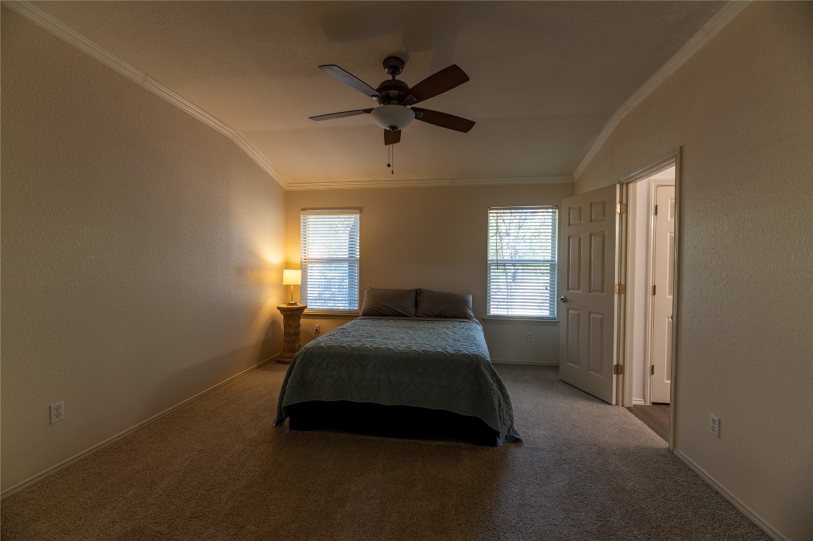 2604 Hutton Lane Leander, TX 78641 - Photo 13 of 27 a bed sitting in a spacious bedroom next to a window