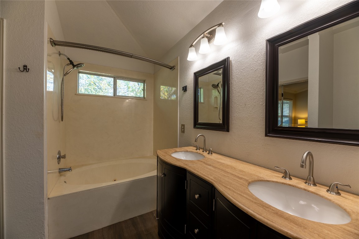 2604 Hutton Lane Leander, TX 78641 - Photo 15 of 27 a bathroom with a granite countertop sink mirror and a bathtub