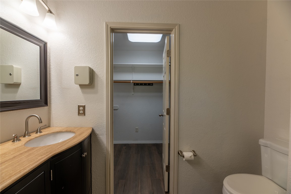 2604 Hutton Lane Leander, TX 78641 - Photo 16 of 27 a bathroom with a granite countertop sink toilet and mirror